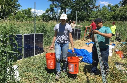 Undergraduate interns Kunal Palawat and Ernesto Vazquez put up solar panels.