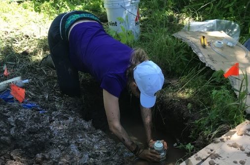 Undergraduate intern Colleen Yancey installs lysimeters.