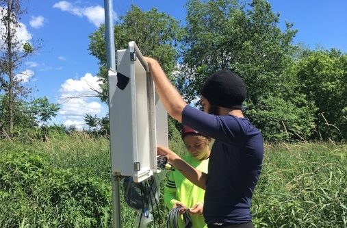 Undergraduate interns Amanda Jackson-Mojica and Ricardo Feliciano set up communication between the sensors and the data logger.